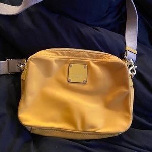 Yellow Henri Bendel crossbody purse.